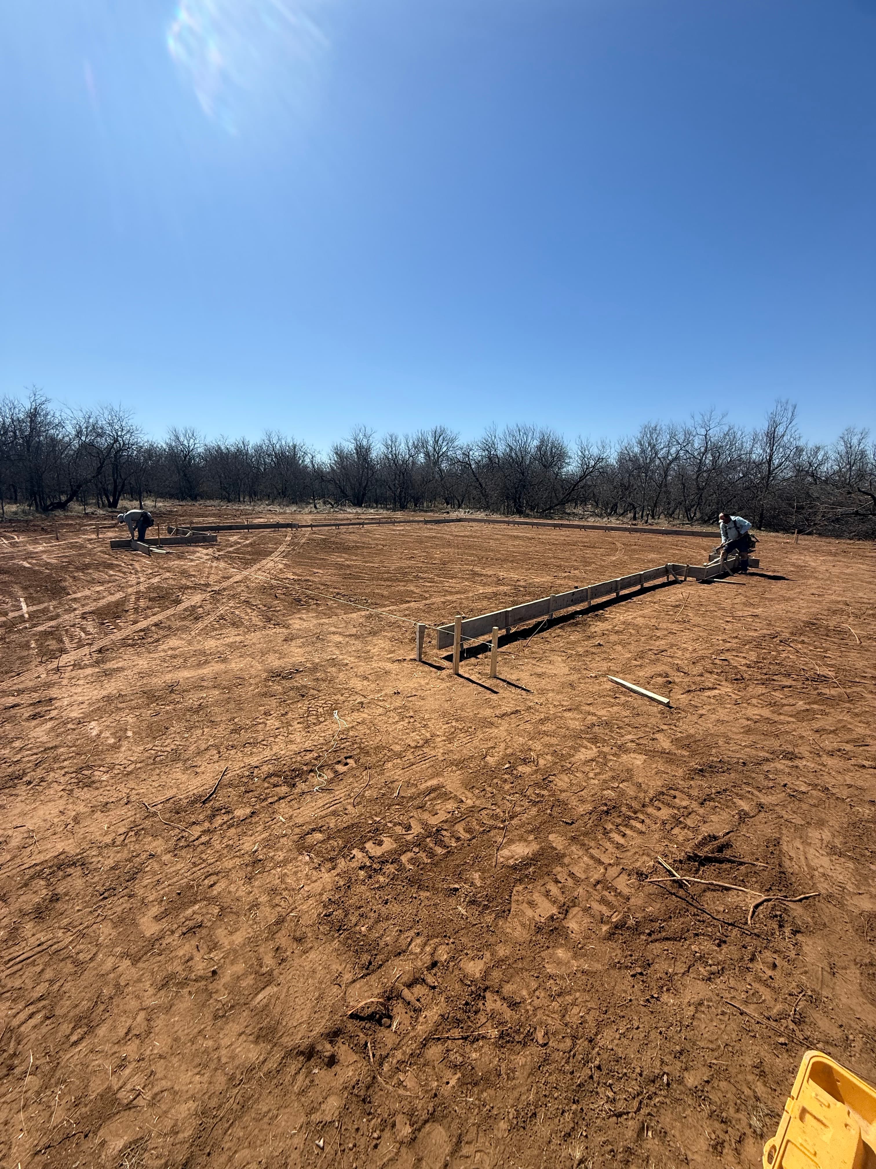 Concrete form stakes set for flatwork in North Texas