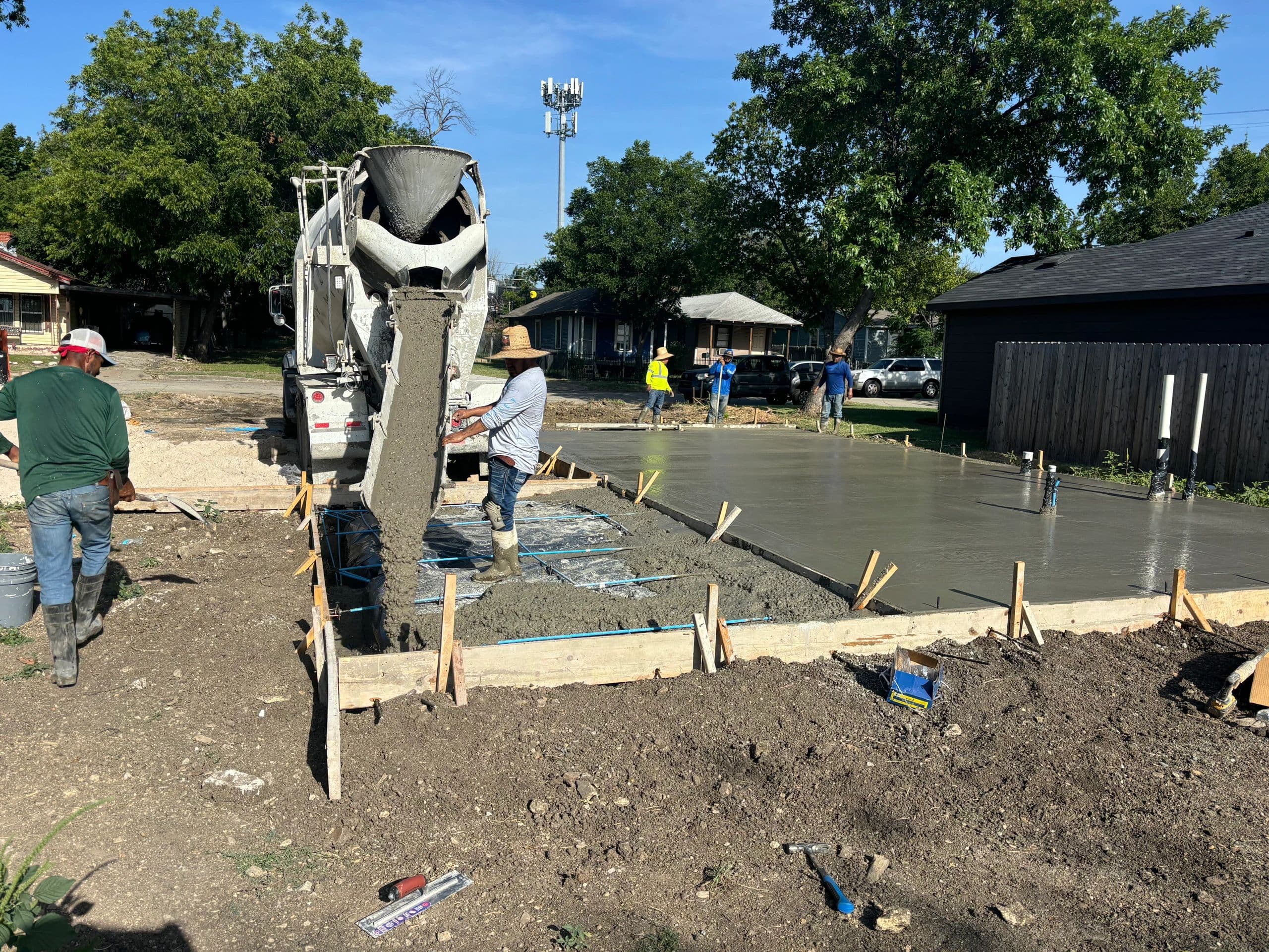 Concrete mixer truck delivering pour for residential slab