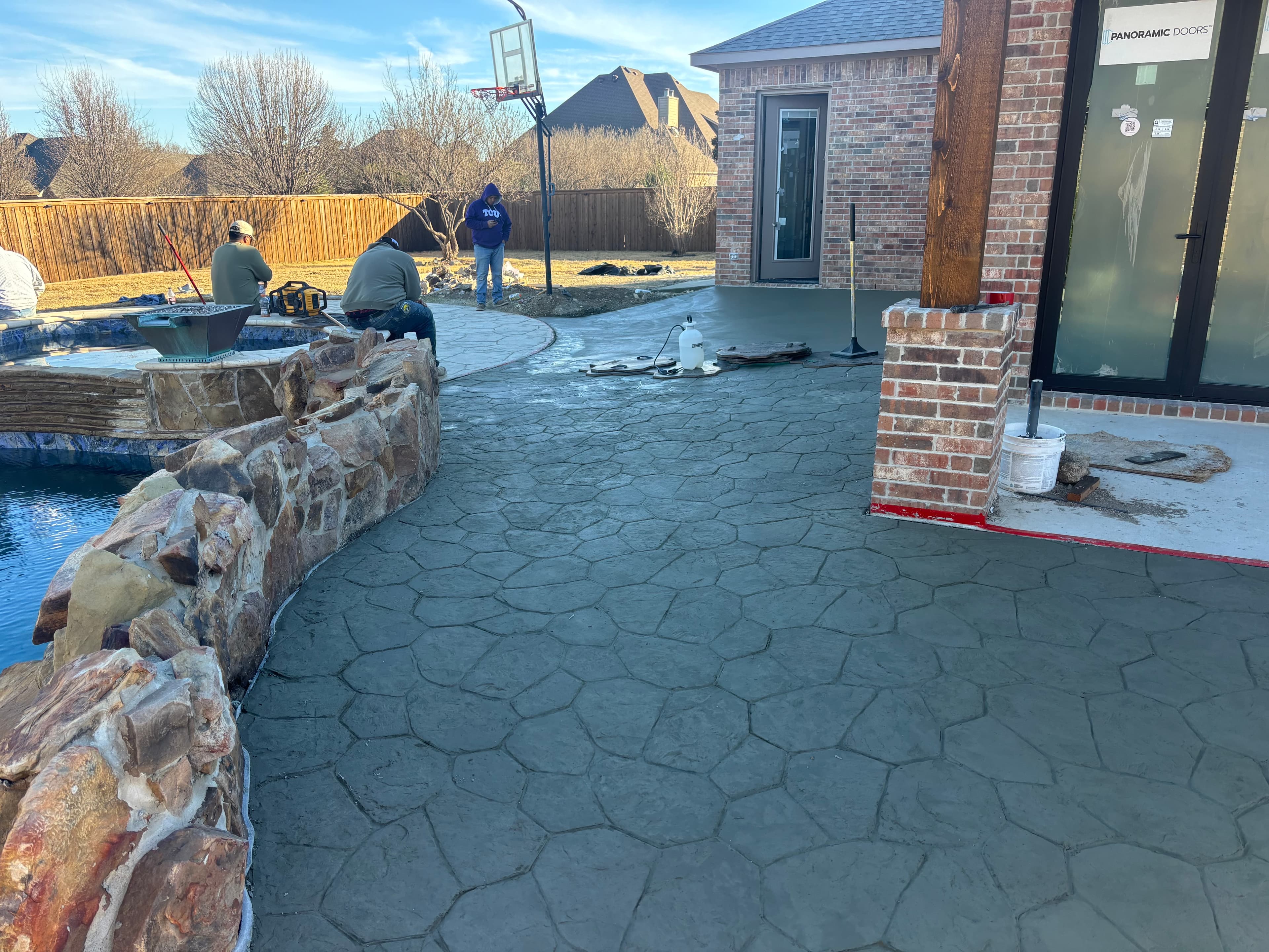 Stamped concrete pool deck installation in North Texas by Pillars Concrete